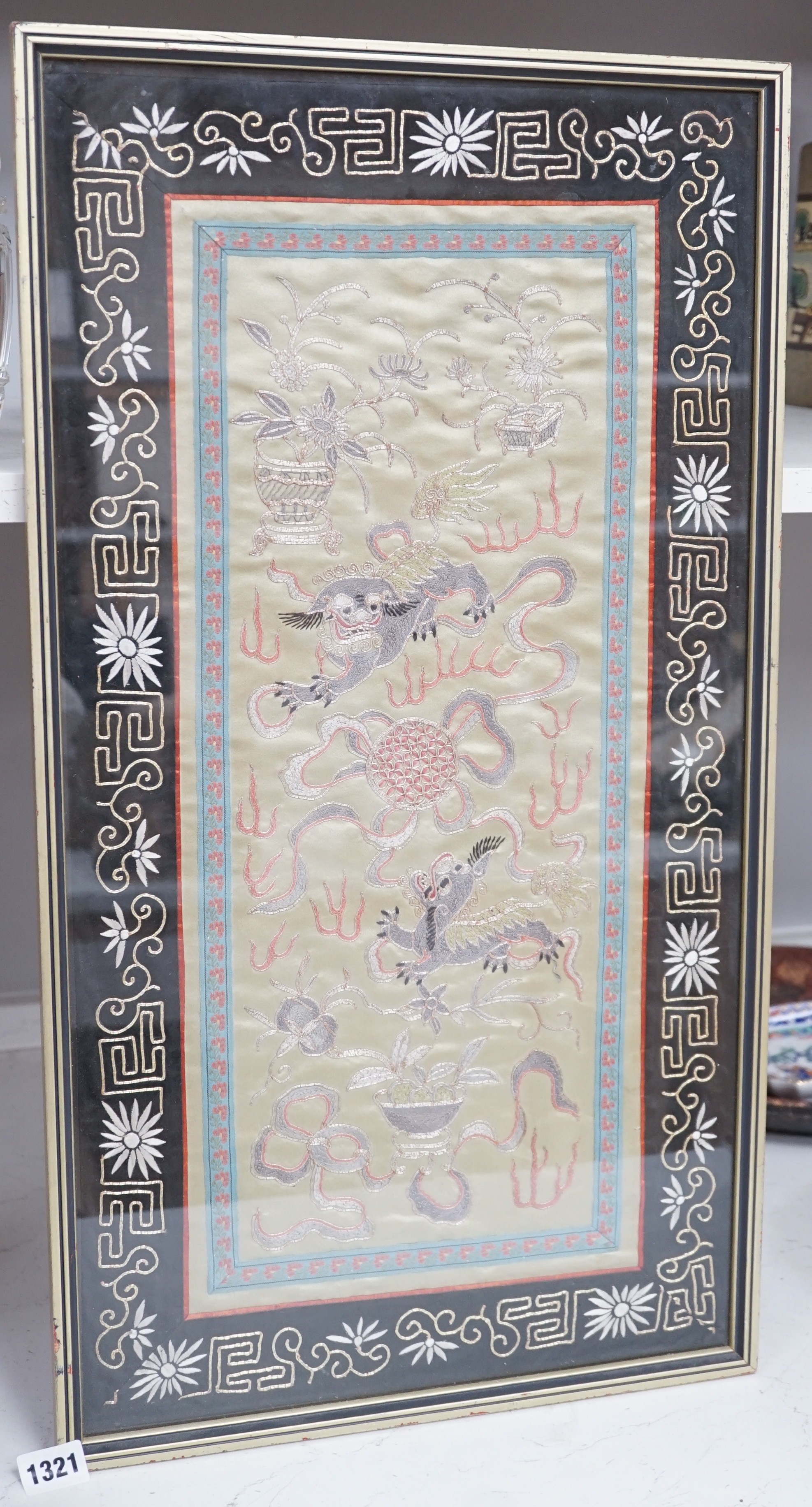 A framed Chinese dragon silk panel. 64 x 34cm